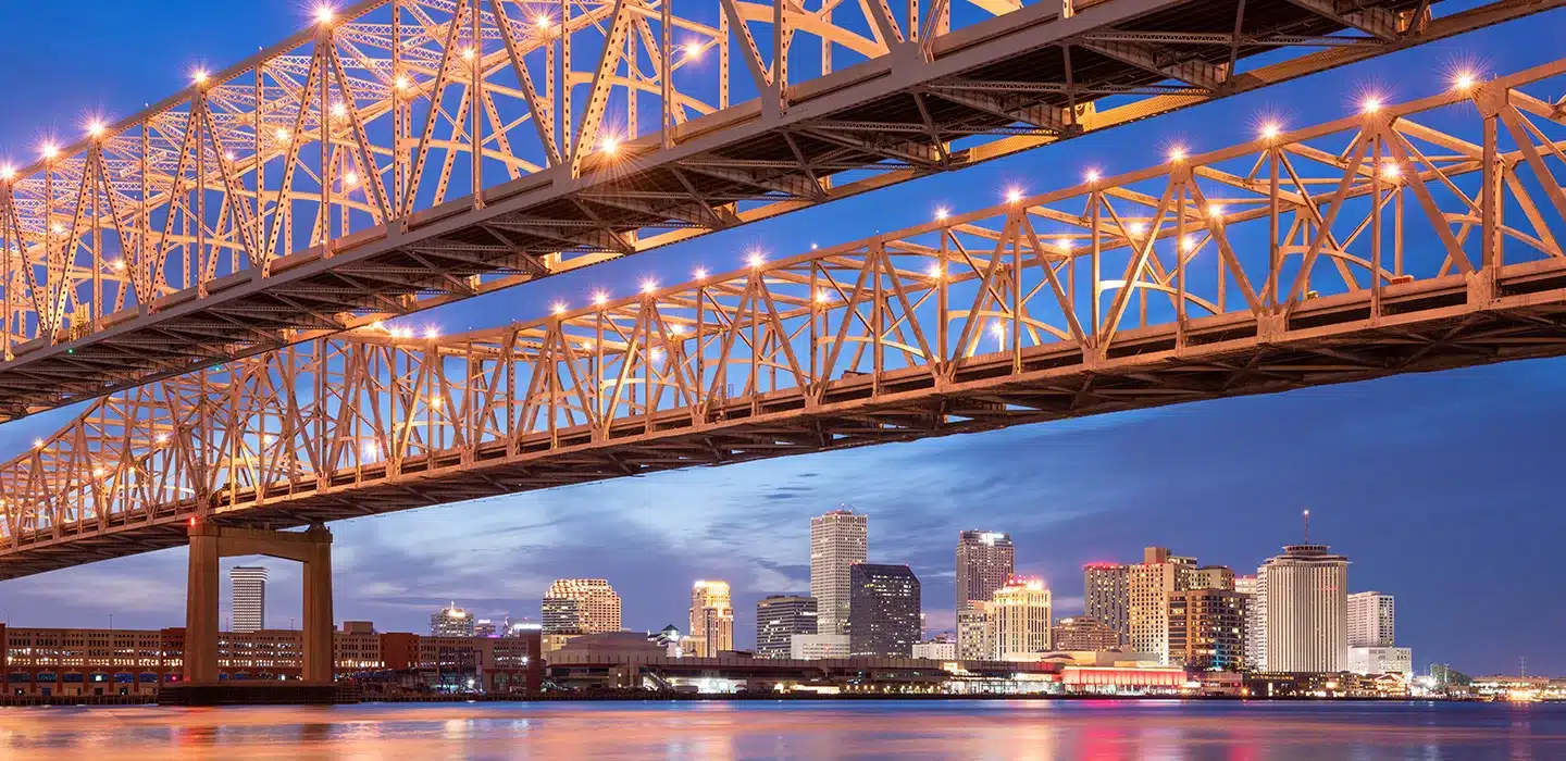 Sunset photo of two bridges over a large river