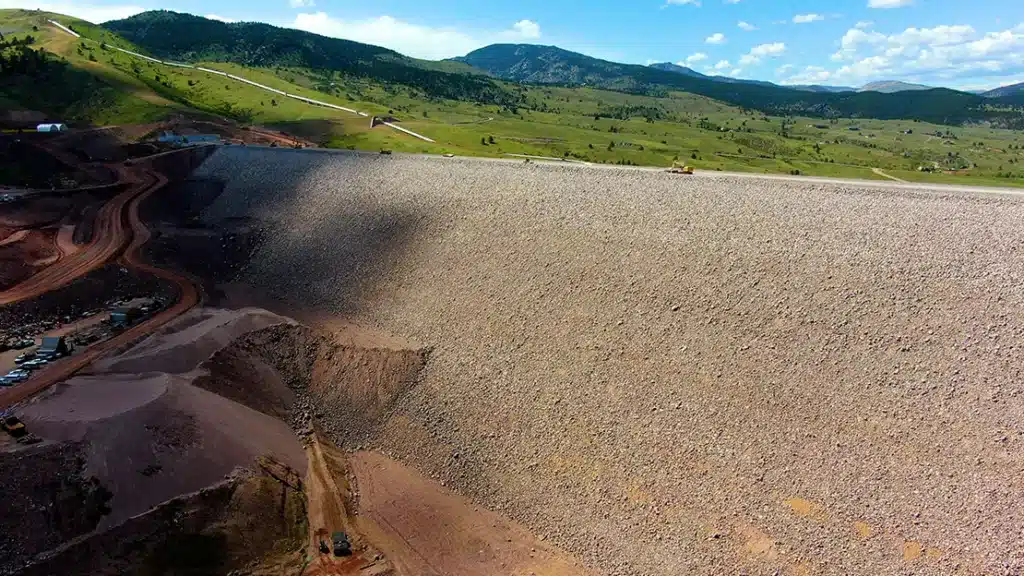 Aerial view of Chimney Hollow Dam with cloud shadows on the left.