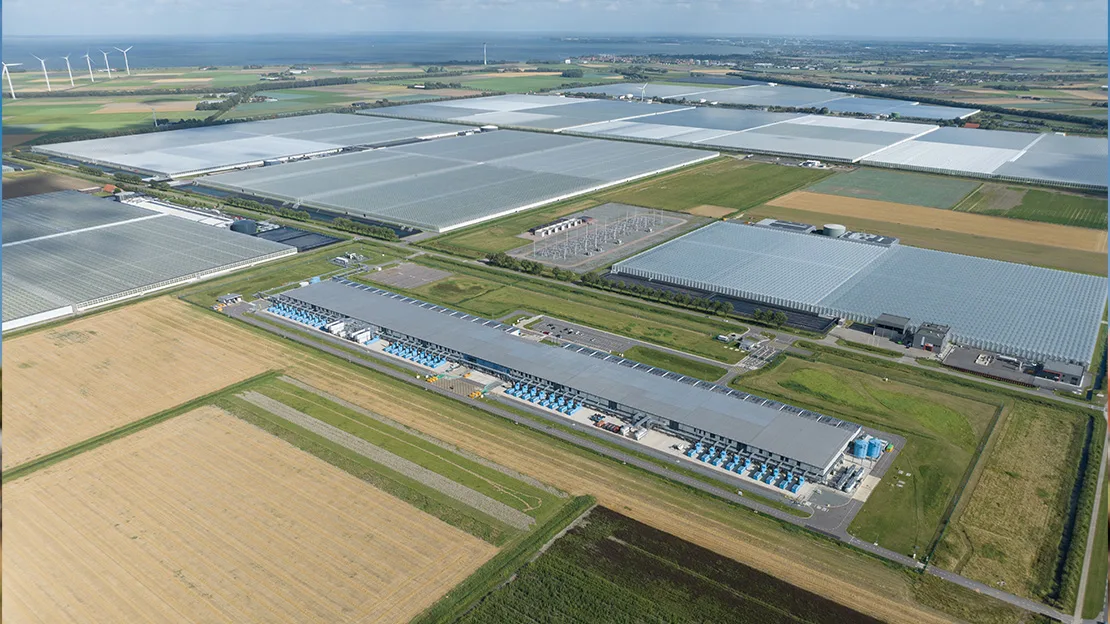 Overhead drone shot of a data center in an open field
